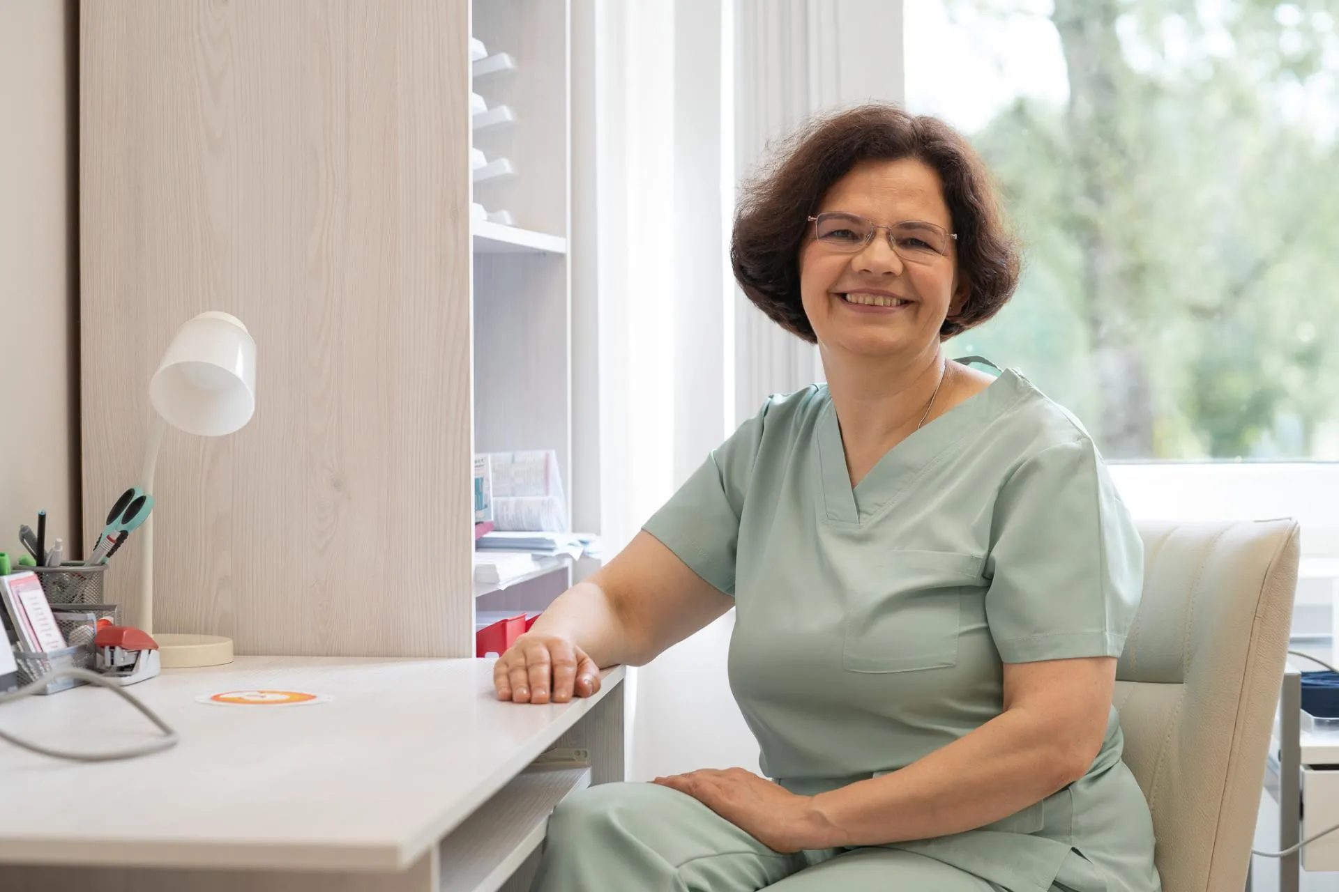 Baiba Stikute - vecmāte - sēžot pie galda